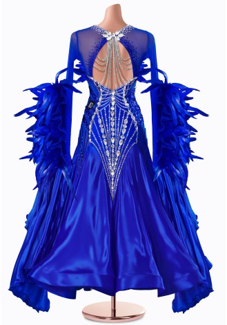 A stunning royal blue ballroom dance gown adorned with feathers and sparkling crystals. The perfect dress for a captivating per