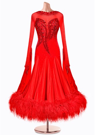 A stunning red ballroom dance gown with long sleeves, a beaded bodice, and a dramatic feather trim.