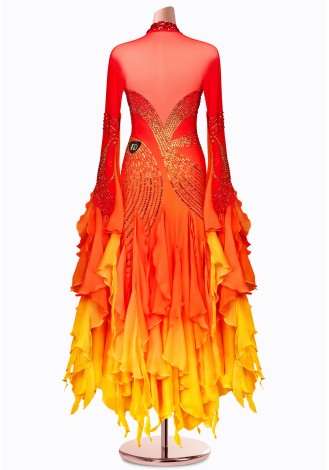 A stunning ombre ballroom dance gown in shades of red, orange, and yellow. The intricate detailing and flowing skirt make it pe