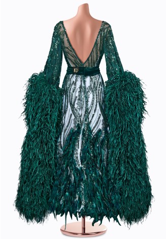 This stunning emerald green ballroom gown features dazzling sequins, long sleeves with dramatic feather accents, and a flatterin