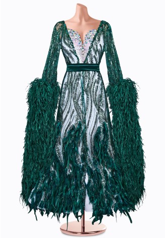 This stunning emerald green ballroom gown features dazzling sequins, long sleeves with dramatic feather accents, and a flatterin