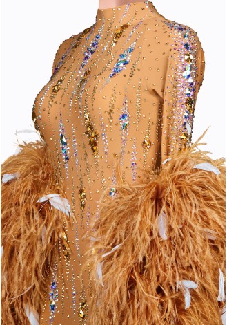 A stunning ballroom dance gown in a warm, sandy hue. The bodice is adorned with sparkling embellishments and the long sleeves f