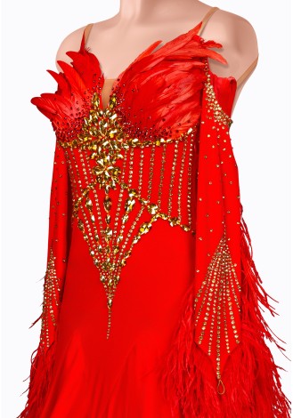 A stunning red ballroom dance gown adorned with gold embellishments and red feather accents.