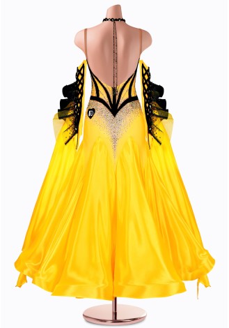 Shine bright in this stunning yellow ballroom dance gown. The black bodice and dramatic sleeves add a touch of elegance.