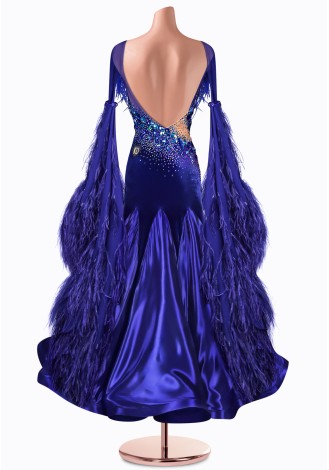 A stunning royal blue ballroom dance gown, adorned with feathers and sparkling embellishments.