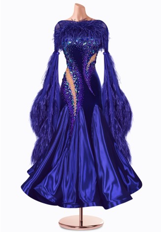 A stunning royal blue ballroom dance gown, adorned with feathers and sparkling embellishments.