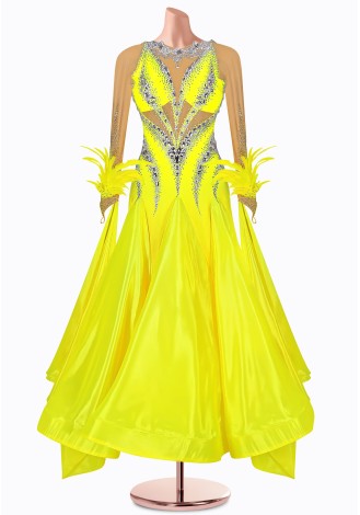 Shine bright in this dazzling yellow ballroom dance gown. The intricate beading and feather details add a touch of elegance.