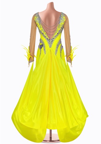 Shine bright in this dazzling yellow ballroom dance gown. The intricate beading and feather details add a touch of elegance.